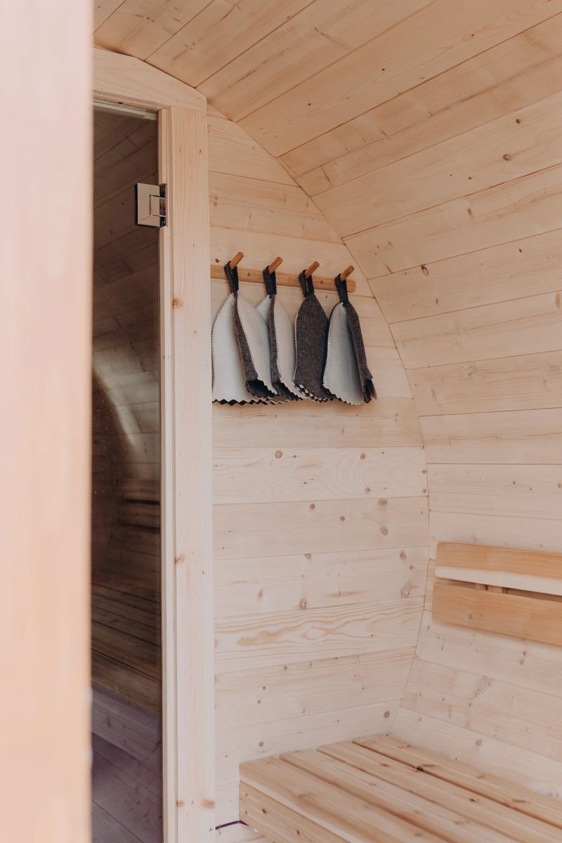 Felt sauna hats hanging inside the cedar sauna