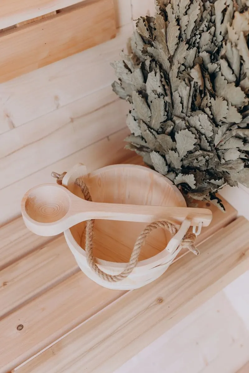Wooden sauna bucket and ladle on the bench