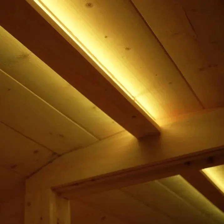 Warm white LED light along the cedar ceiling