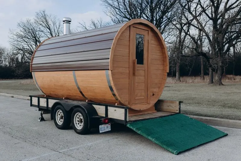Side view of the barrel sauna on its trailer